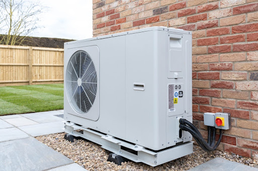 An outdoor heat pump unit installed outside of a home.