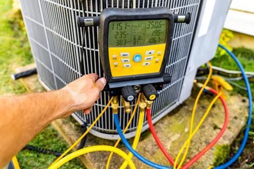 A technician performing maintenance on an outdoor AC unit.