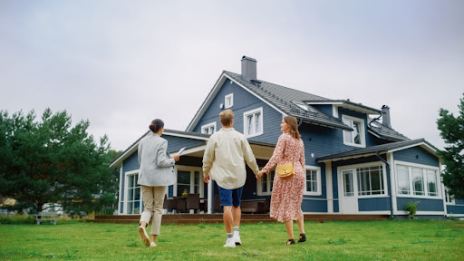 A real estate agent showing a couple a house.