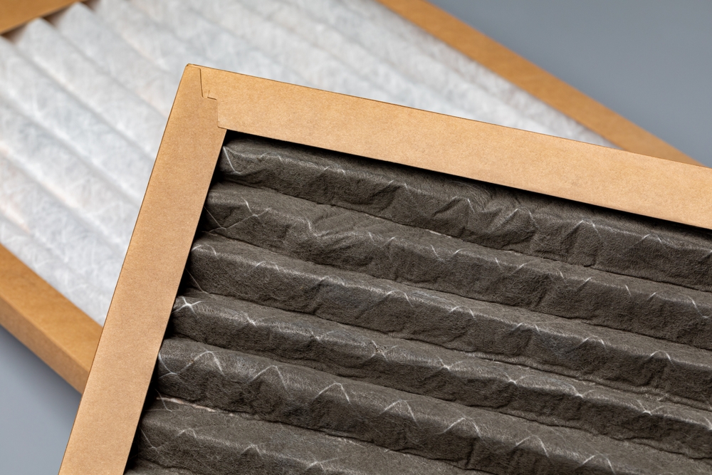 dirty and new air filter to show why it's important to change the filter to reduce AC costs